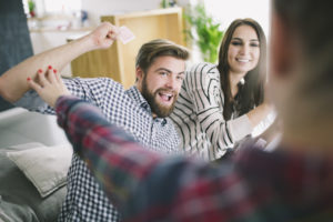 people-competing-while-playing-cards-with-fun_23-2147745130